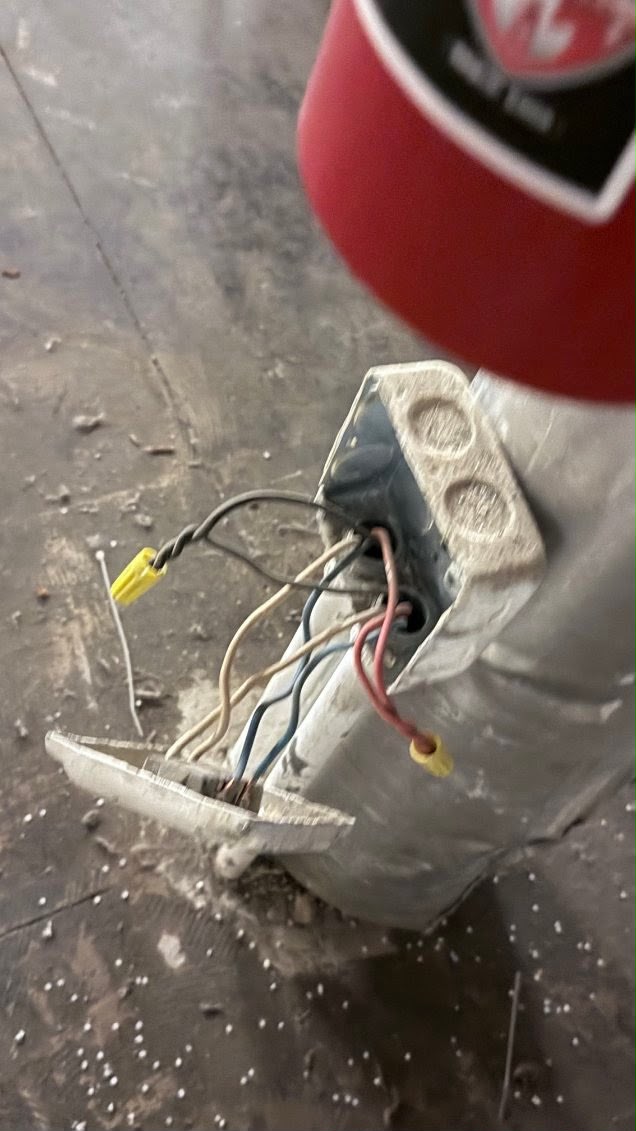 Open metal electrical junction box with exposed wiring