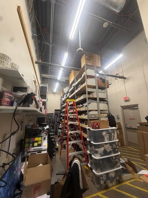 Ladder and overhead lighting in a commercial stockroom