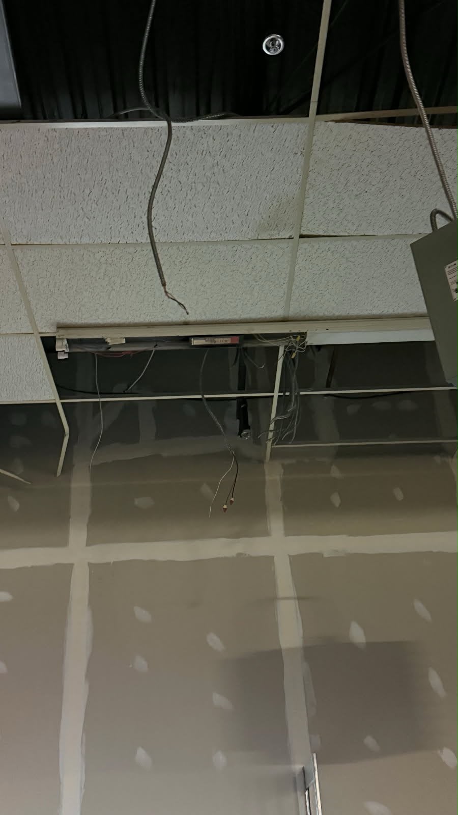 Suspended ceiling grid and partially finished commercial drywall