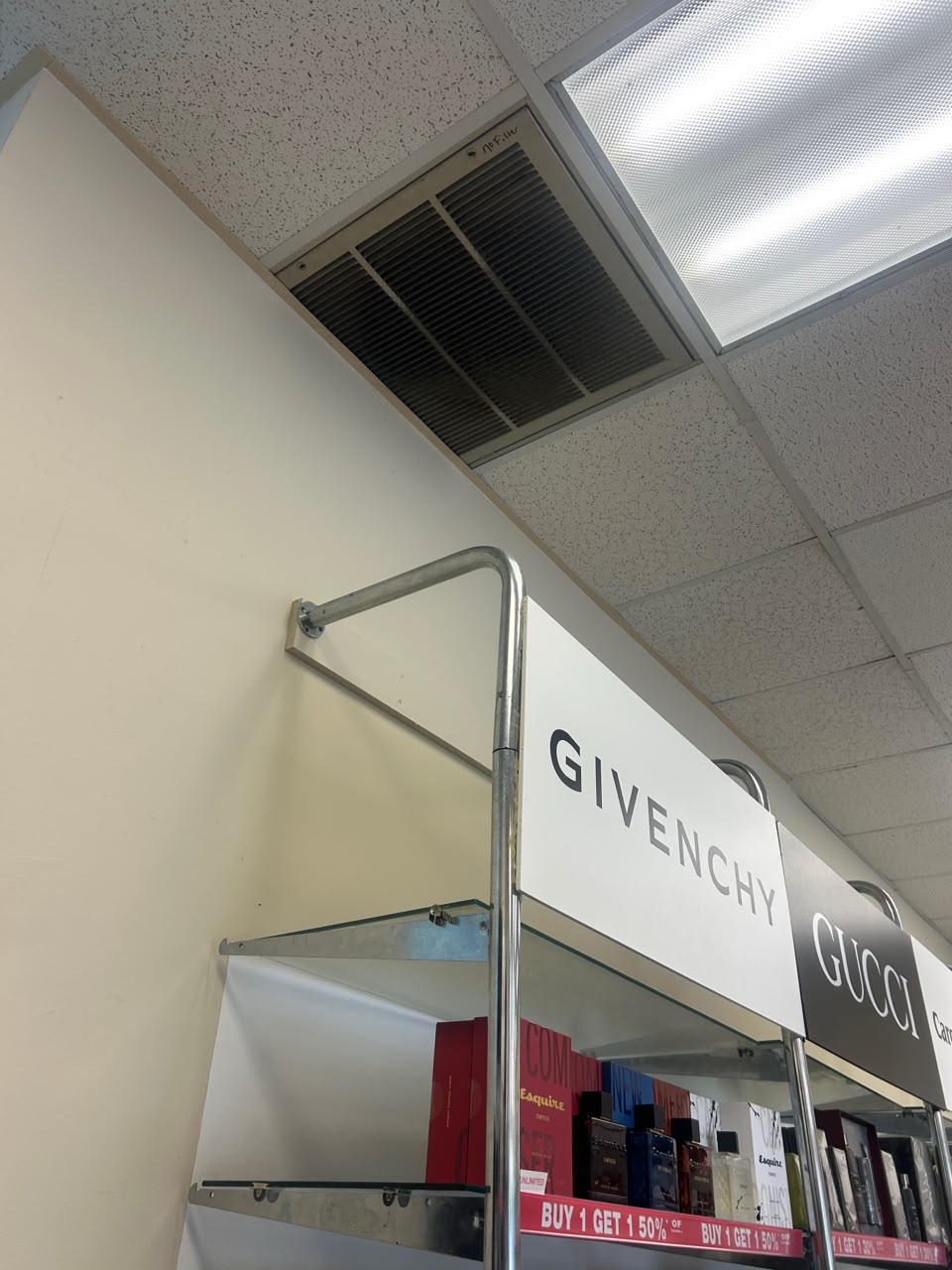 Ceiling ventilation grille and lighting above retail shelving
